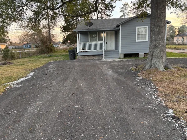 a view of a house with a yard and garage