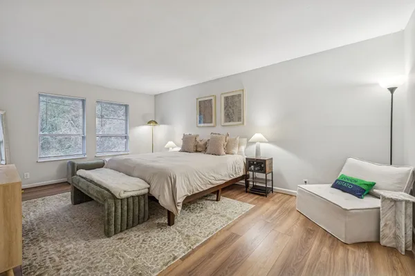 a bedroom with a bed and wooden floor