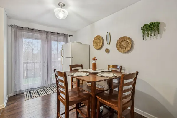a dining room with a wooden table and chairs