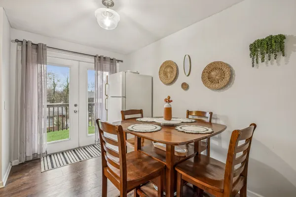 a view of a dining area with furniture and a large window