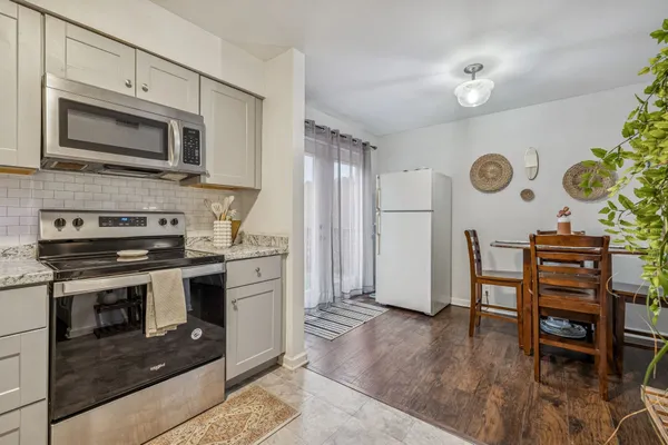 a kitchen with stainless steel appliances granite countertop a stove and a microwave