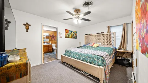a bedroom with a bed and a chandelier