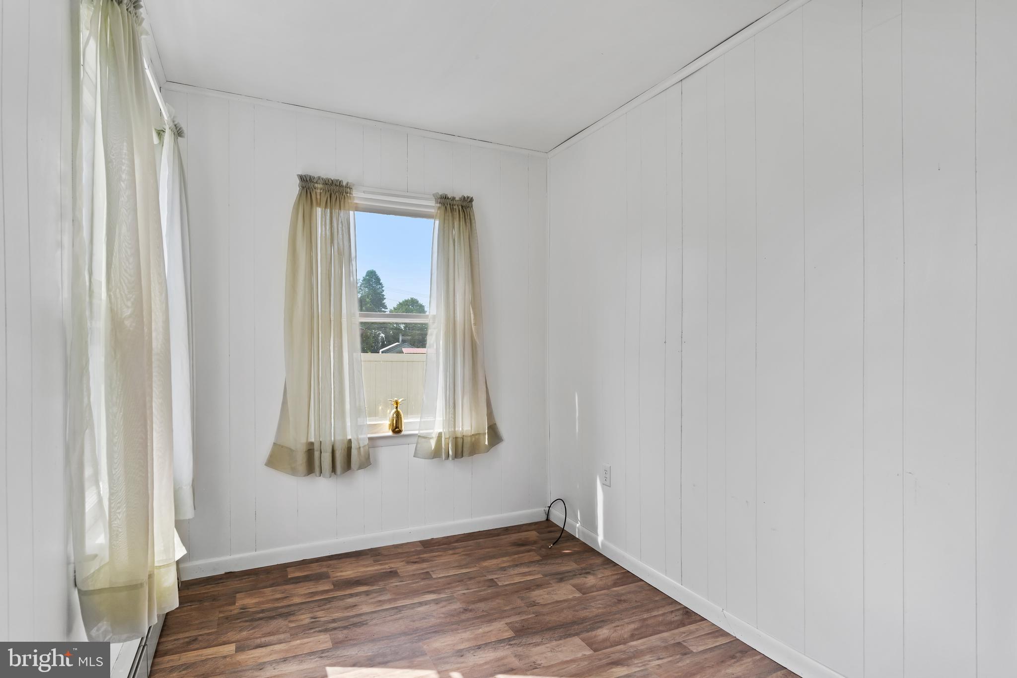 2103 Smoketown Road Fayetteville, PA 17222 - Photo 16 of 28 an empty room with wooden floor cabinet and windows