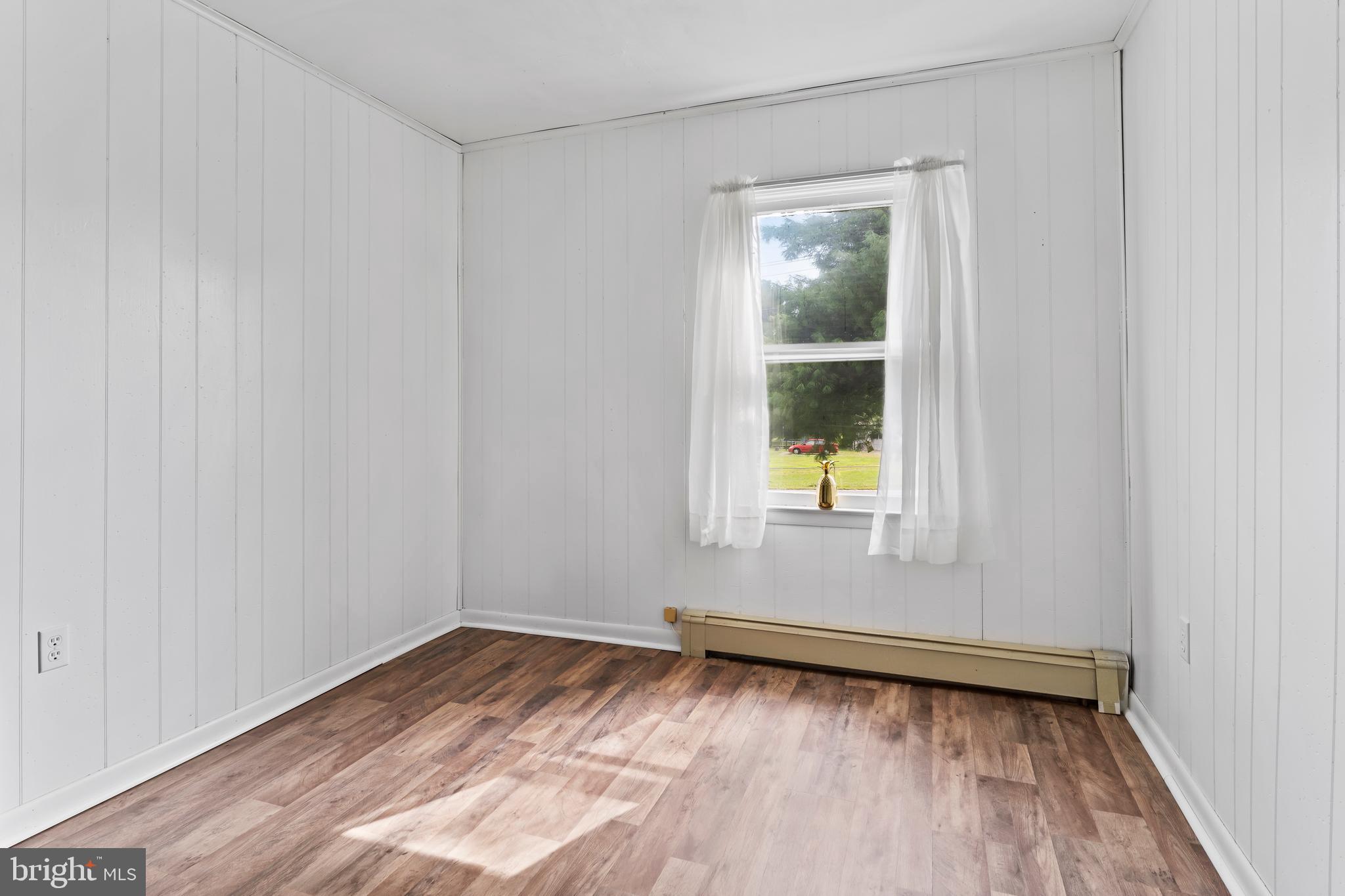 2103 Smoketown Road Fayetteville, PA 17222 - Photo 19 of 28 a view of an empty room with wooden floor and a window