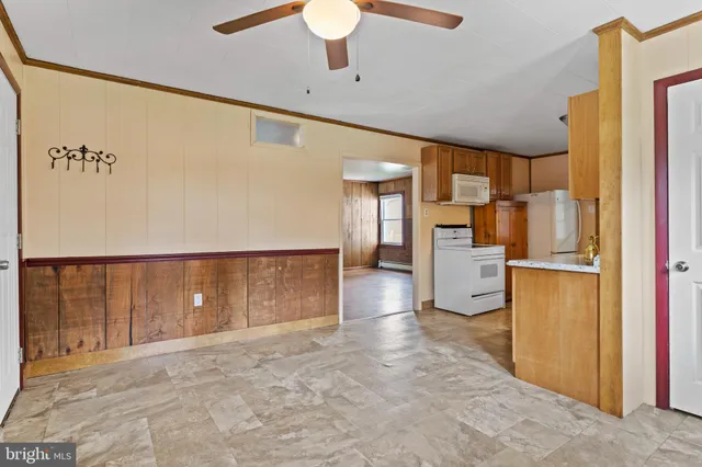 a view of a kitchen with a refrigerator a stove top oven and a refrigerator