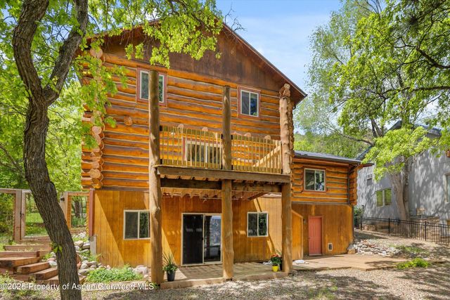 a view of a house with a tree