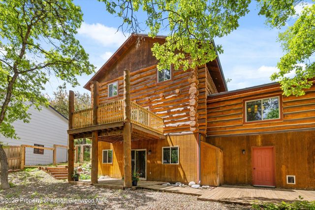 a view of a house with wooden fence