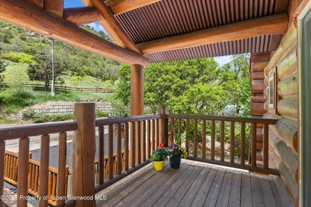 a view of a house with wooden fence