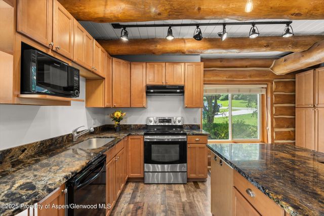 a view of a wooden deck next to a yard