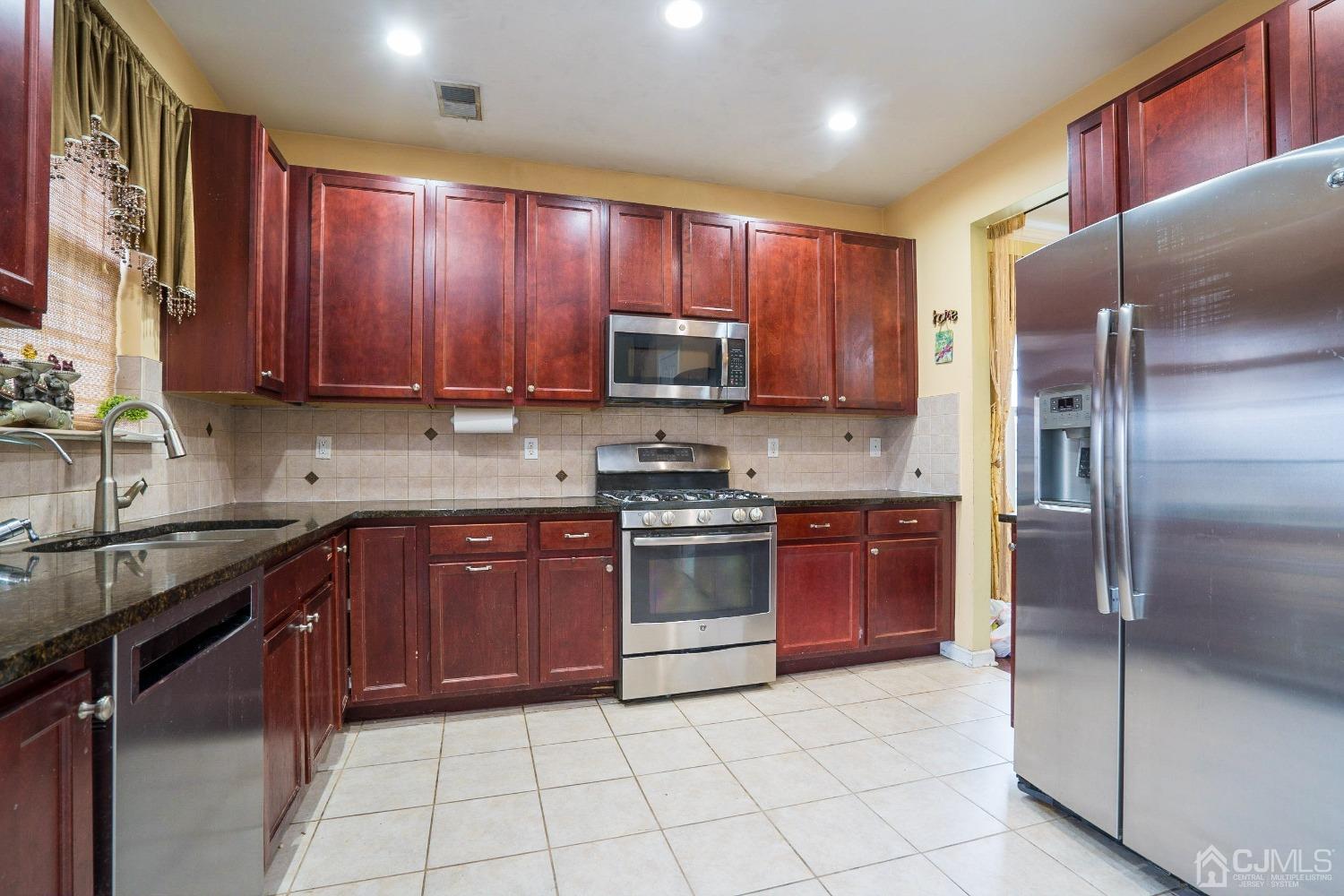 8 Maxwell Road Monroe Township, NJ 08831 - Photo 11 of 40 a kitchen with stainless steel appliances granite countertop a stove refrigerator and a sink