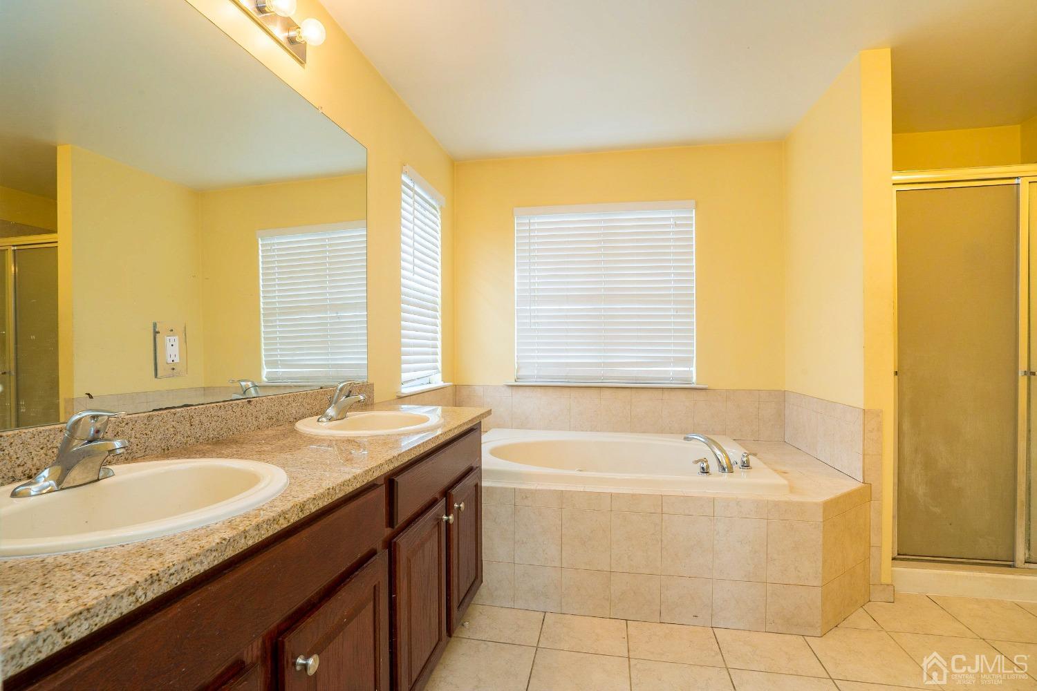 8 Maxwell Road Monroe Township, NJ 08831 - Photo 16 of 40 a bathroom with a granite countertop sink and a bathtub