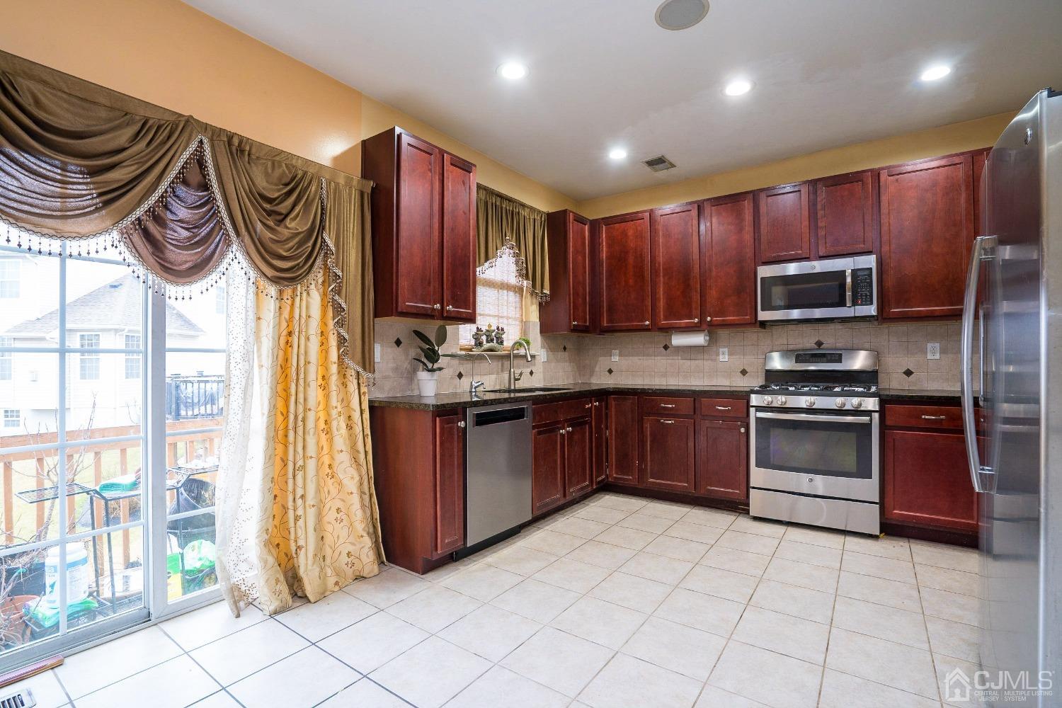 8 Maxwell Road Monroe Township, NJ 08831 - Photo 7 of 40 a kitchen with stainless steel appliances granite countertop a stove a sink and a microwave