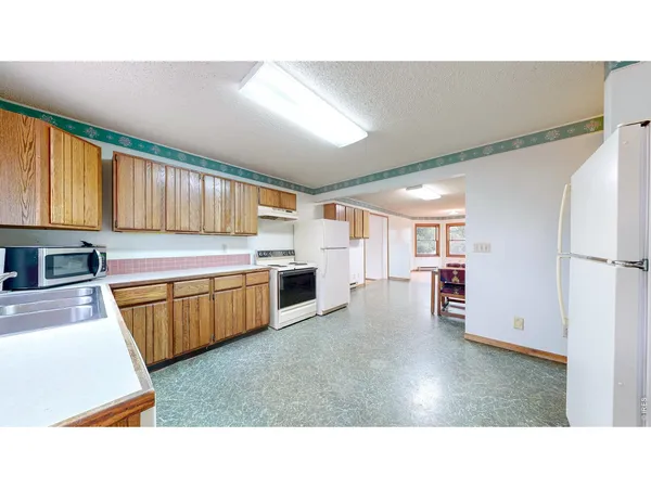 a kitchen with a refrigerator and a sink