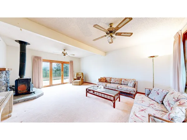 a living room with furniture and a dining table