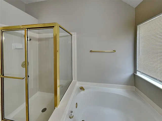 a bathroom with a shower and a tub
