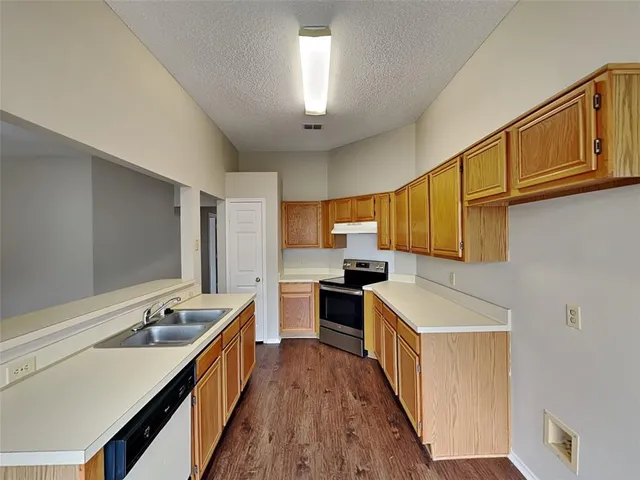 a kitchen with a stove a sink and a refrigerator