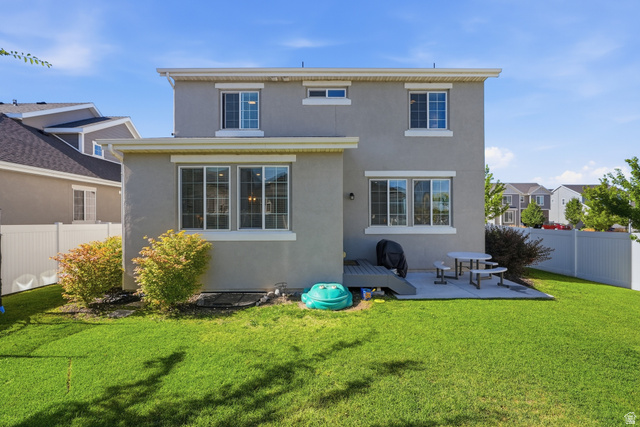 3244 West 1670th Street North Provo, UT 84601 - Photo 48 of 56 Spacious backyard featuring a manicured lawn, a gray deck, and a concrete patio area
