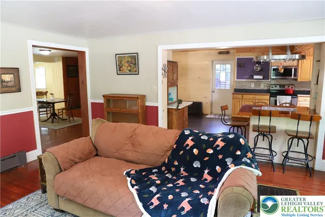 a living room with furniture a couch and a floor to ceiling window