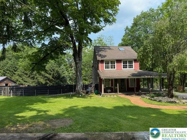 a front view of a house with a yard table and chairs