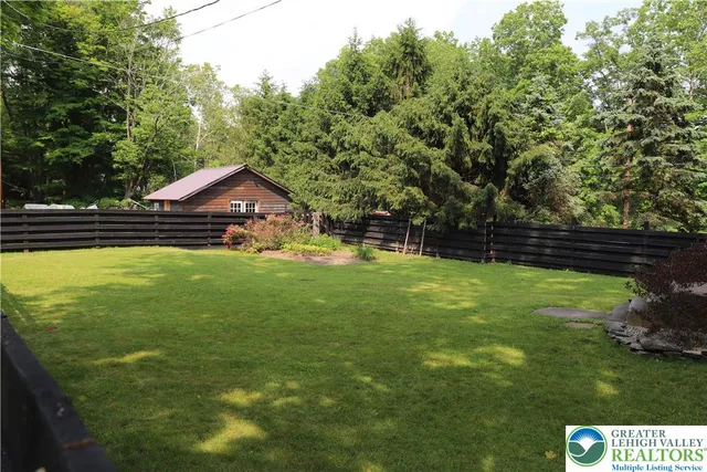 a front view of a house with a yard table and chairs