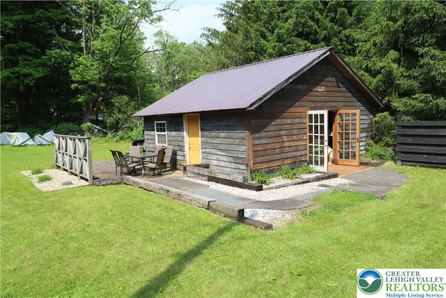 a view of backyard with swimming pool and patio