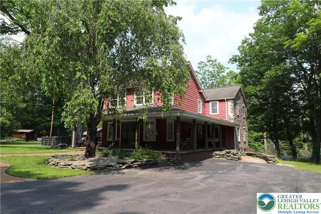 a front view of a house with a yard table and chairs
