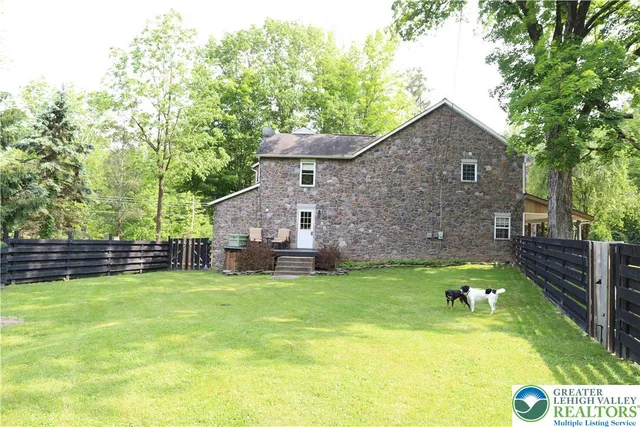 a house view with a sitting space and garden