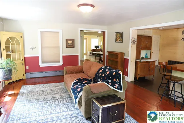 a bedroom with furniture and wooden floor
