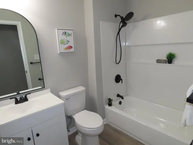 a bathroom with a toilet and a tub