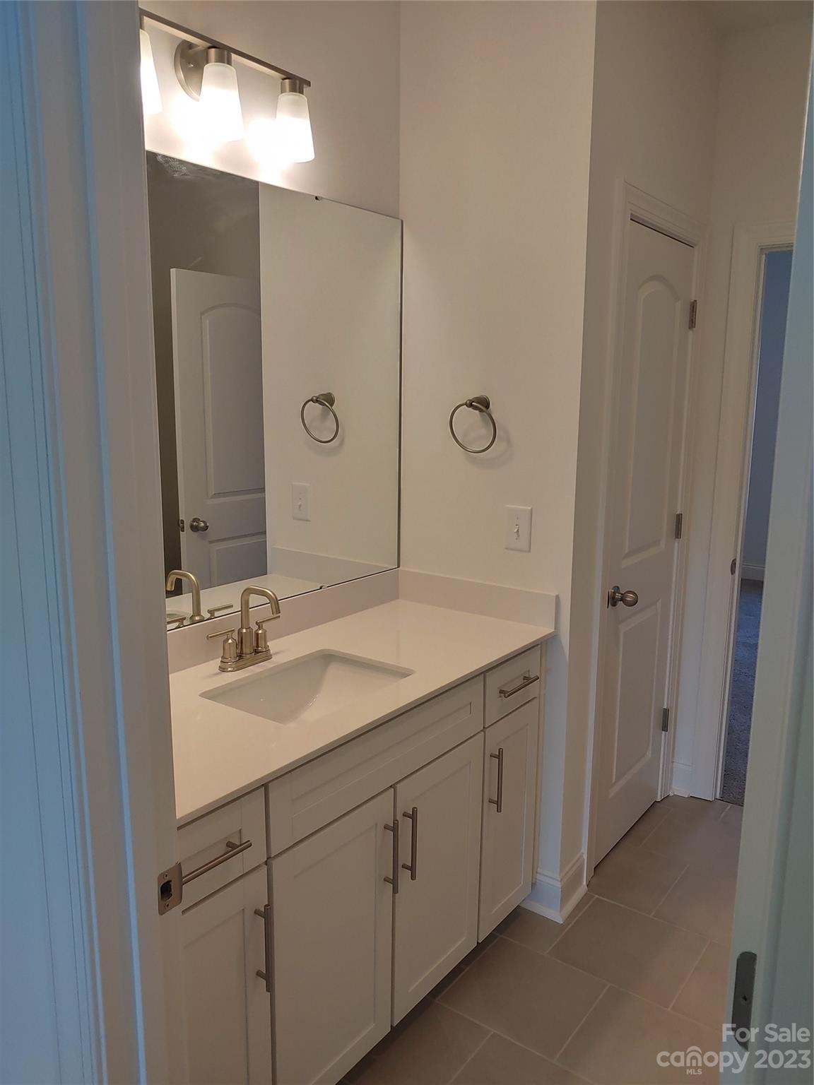 1805 Edgewater Drive Northwest Conover, NC 28613 - Photo 13 of 17 a bathroom with a granite countertop sink a mirror and a