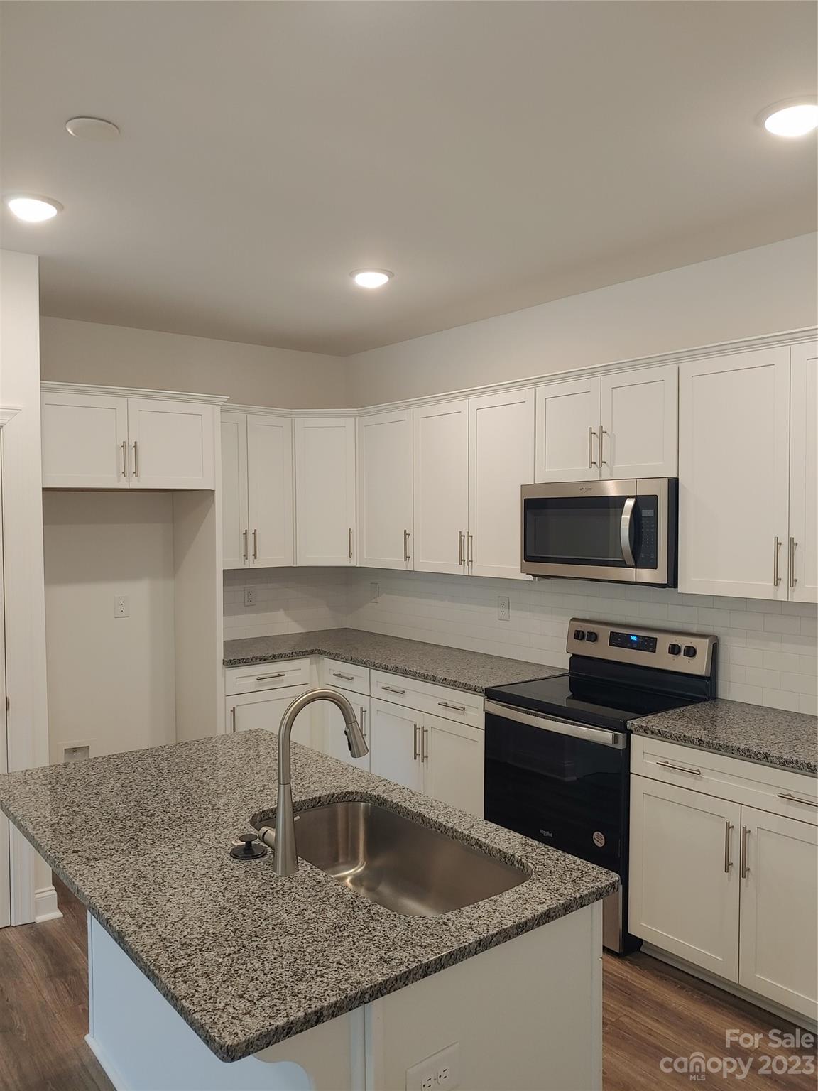 1805 Edgewater Drive Northwest Conover, NC 28613 - Photo 6 of 17 a kitchen with granite countertop a sink a stove and cabinets
