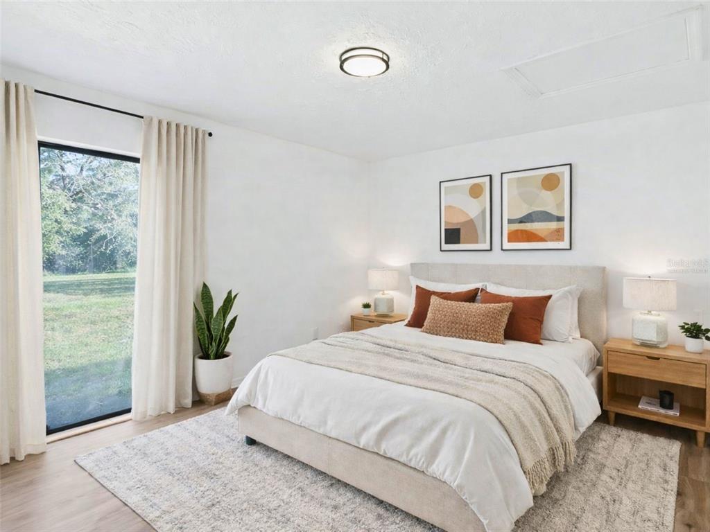 5911 Northwest 9th Street Ocala, FL 34482 - Photo 15 of 37 a bedroom with a bed and painting on the wall