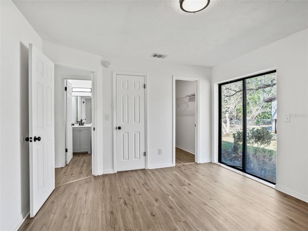 5911 Northwest 9th Street Ocala, FL 34482 - Photo 18 of 37 an empty room with wooden floor and windows