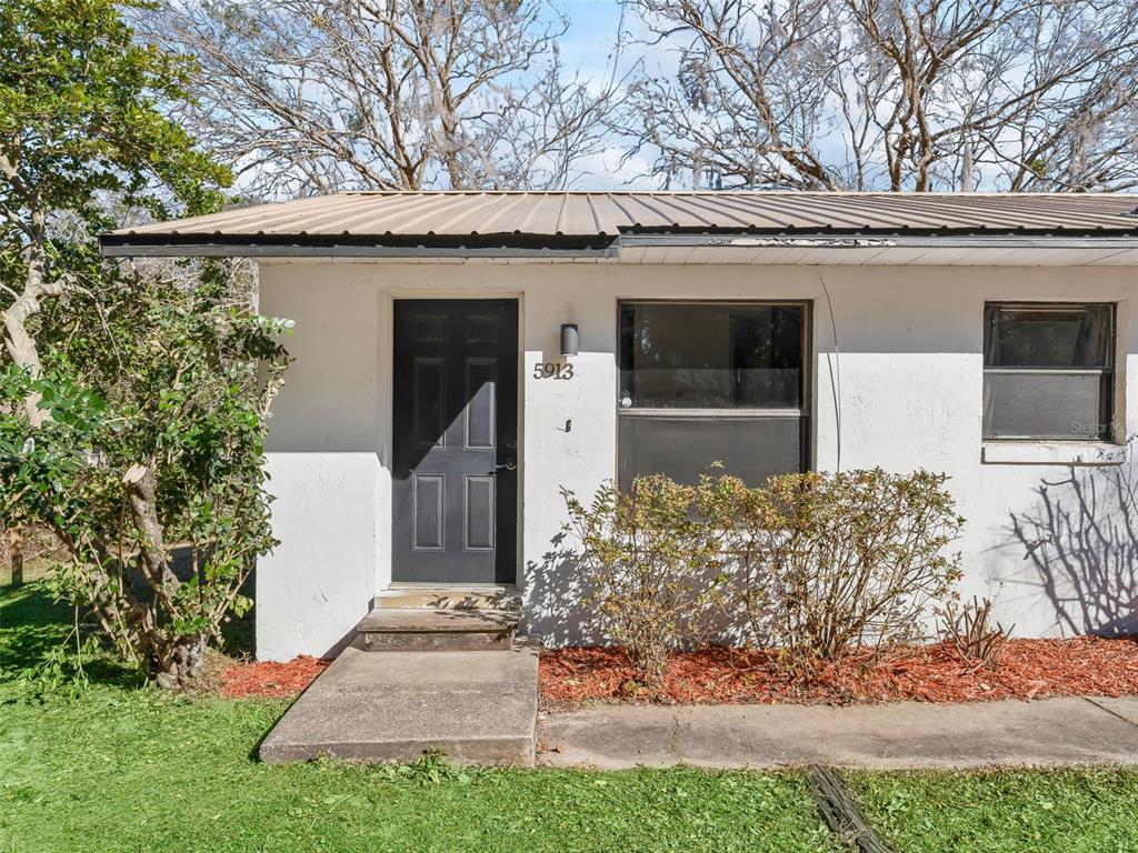 5911 Northwest 9th Street Ocala, FL 34482 - Photo 21 of 37 a front view of a house with garden