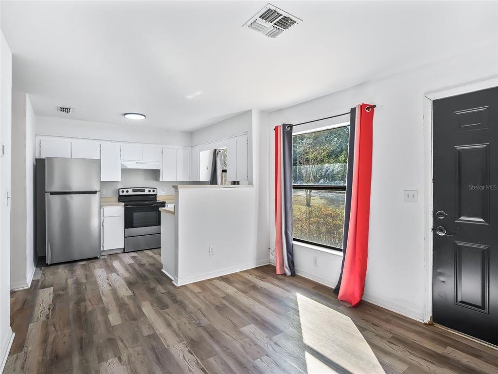 5911 Northwest 9th Street Ocala, FL 34482 - Photo 25 of 37 a kitchen with a refrigerator and wooden floor