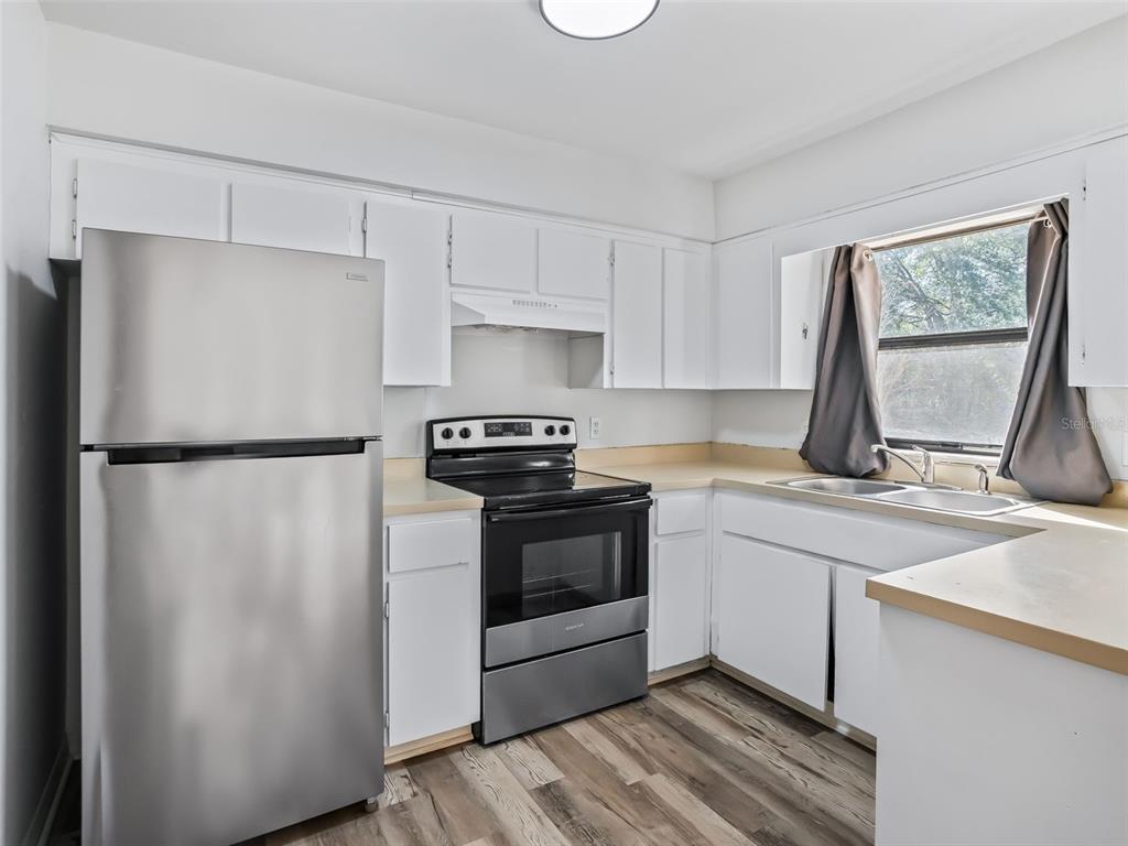 5911 Northwest 9th Street Ocala, FL 34482 - Photo 27 of 37 a kitchen with a refrigerator sink and stove