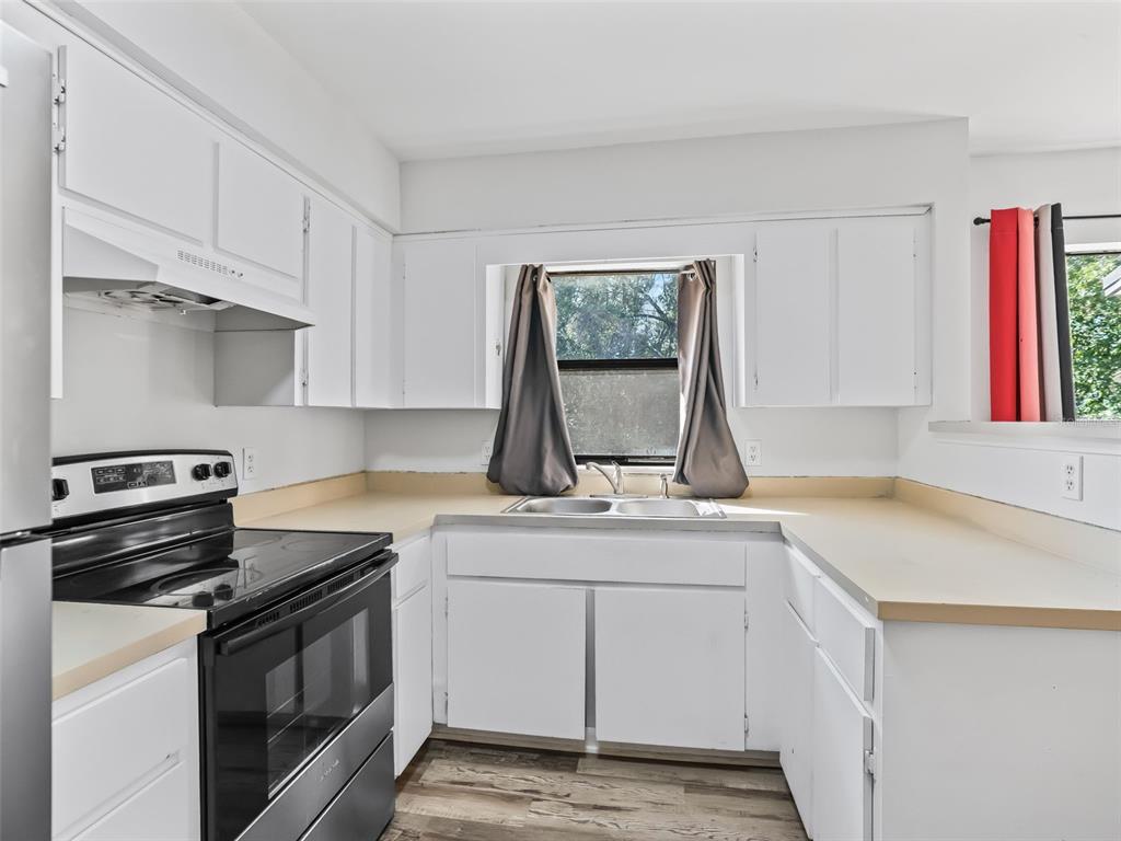 5911 Northwest 9th Street Ocala, FL 34482 - Photo 28 of 37 a kitchen with a sink stove and cabinets
