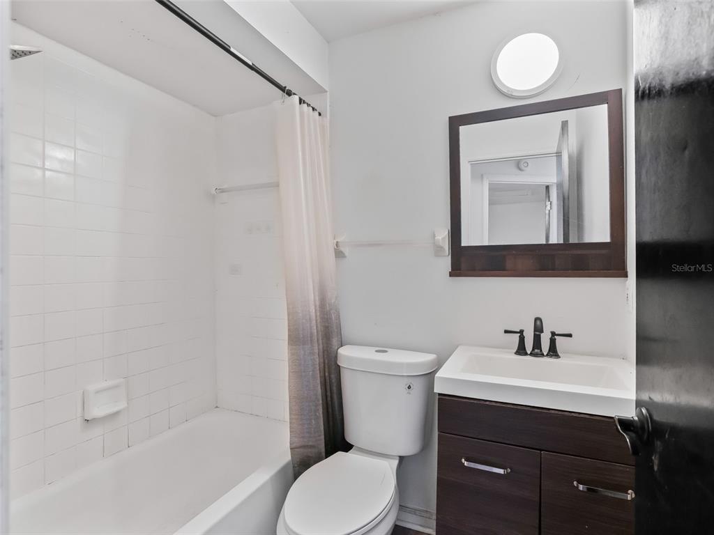 5911 Northwest 9th Street Ocala, FL 34482 - Photo 34 of 37 a bathroom with a toilet a sink and bathtub