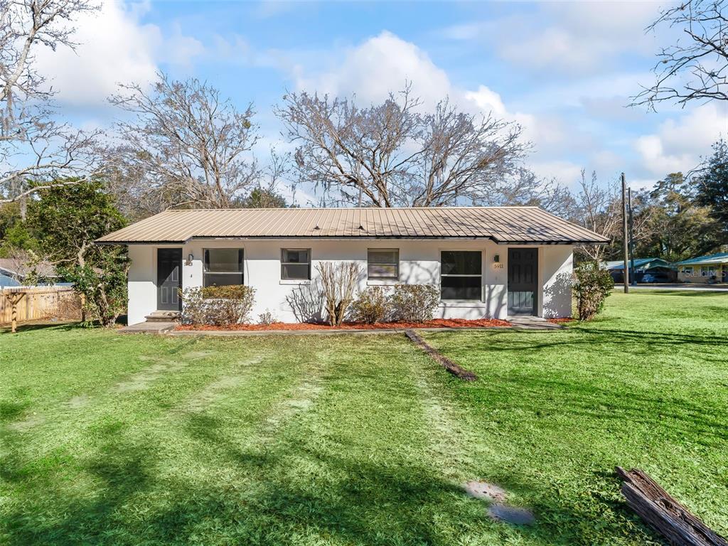 5911 Northwest 9th Street Ocala, FL 34482 - Photo 35 of 37 a front view of a house with a garden