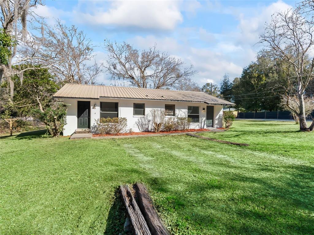 5911 Northwest 9th Street Ocala, FL 34482 - Photo 36 of 37 a view of a house with a backyard patio and a garden