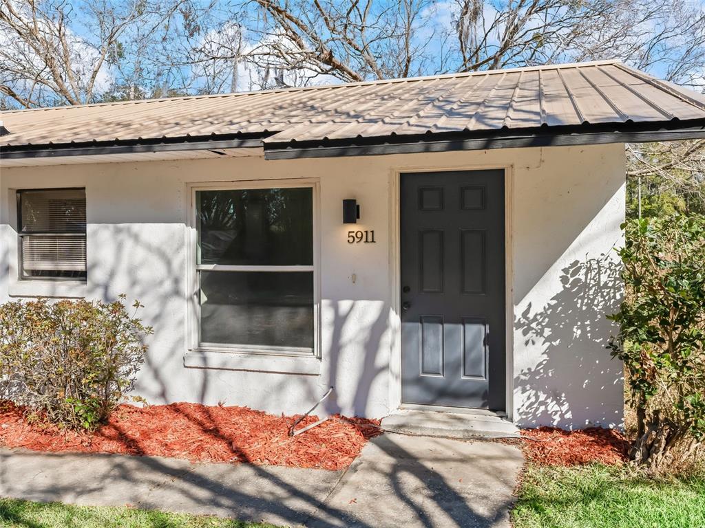 5911 Northwest 9th Street Ocala, FL 34482 - Photo 6 of 37 a view of a house with a door and wooden walls