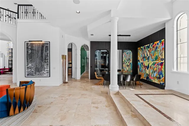 a large kitchen with kitchen island a large counter top space a sink stainless steel appliances and cabinets