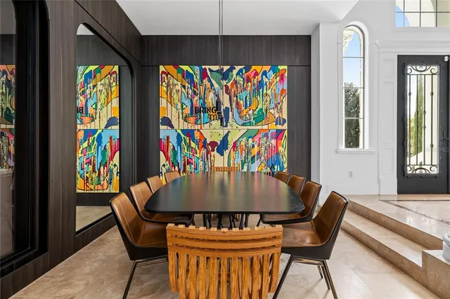 a dining room with furniture and a large window