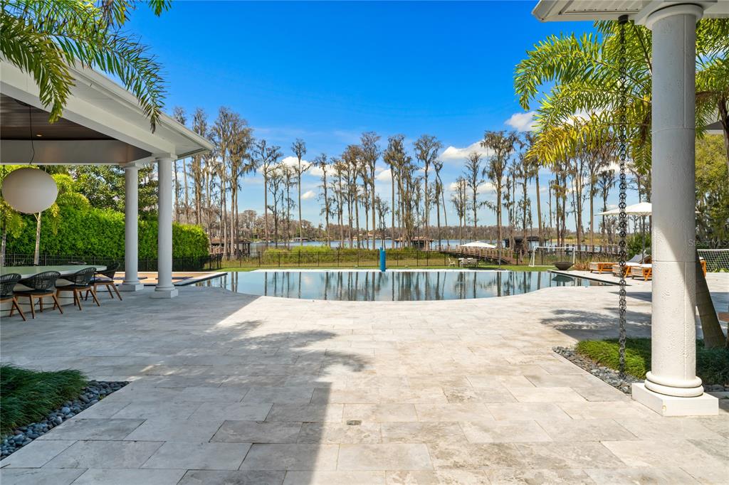 9343 Tibet Pointe Circle Windermere, FL 34786 - Photo 70 of 98 a view of swimming pool with outdoor seating and plants