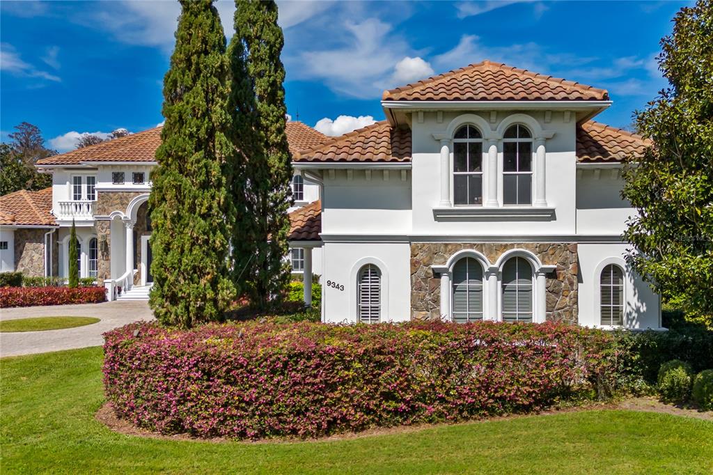 9343 Tibet Pointe Circle Windermere, FL 34786 - Photo 7 of 98 a view of a white house with a yard