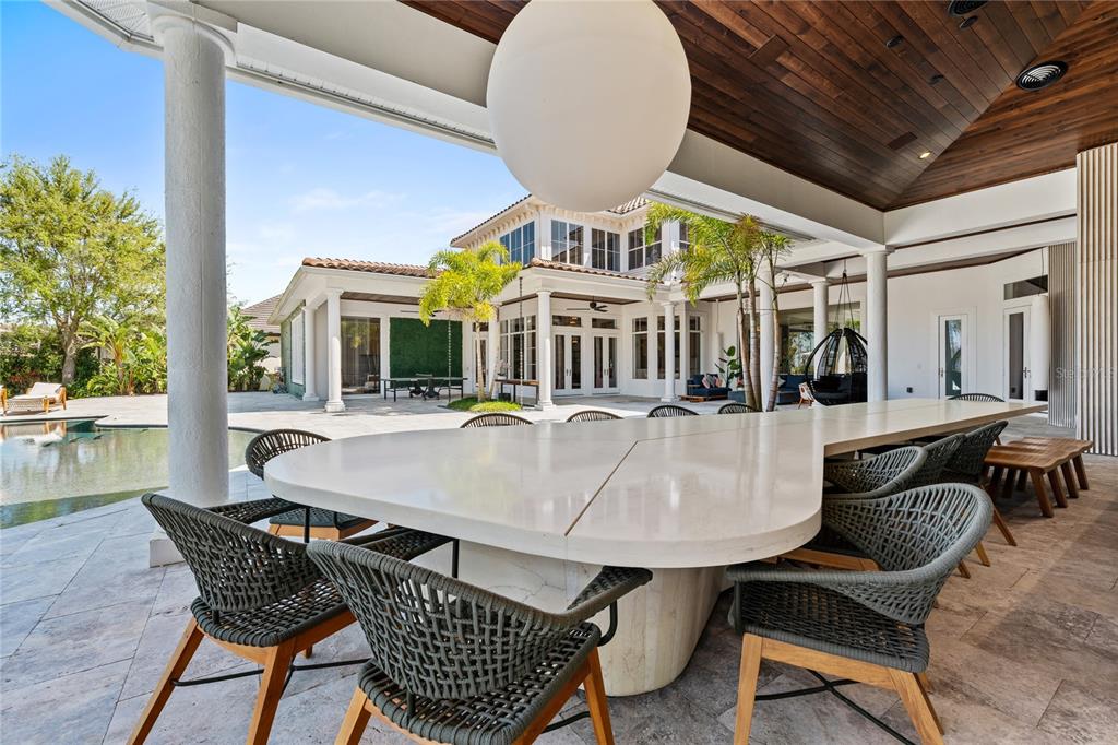 9343 Tibet Pointe Circle Windermere, FL 34786 - Photo 80 of 98 a view of a patio with couches table and chairs and potted plants