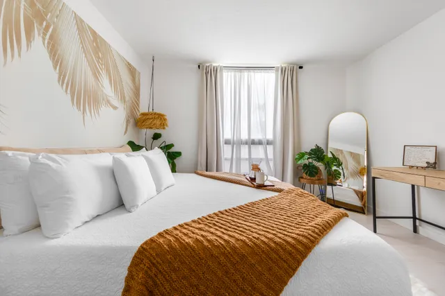 a bedroom with a bed and a table