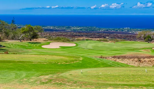 a view of a ocean with a building in the background
