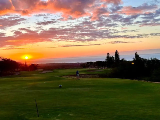 a bedroom with a bed and painting on the wall