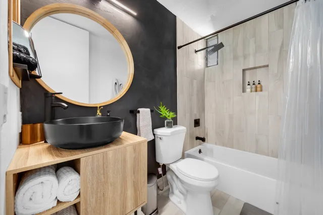 a bathroom with a toilet a sink and a mirror